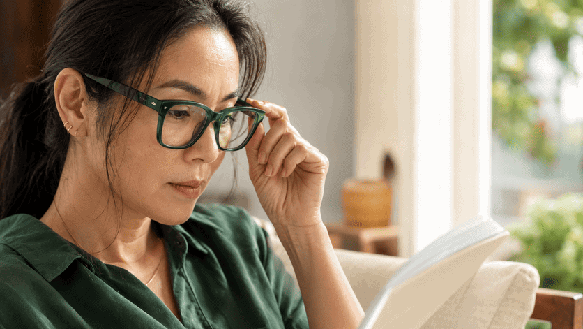 mature-woman-reading-book-with-reading-glasses